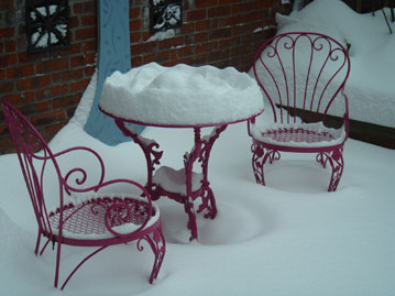 Table and chairs covered with nine inches of snow